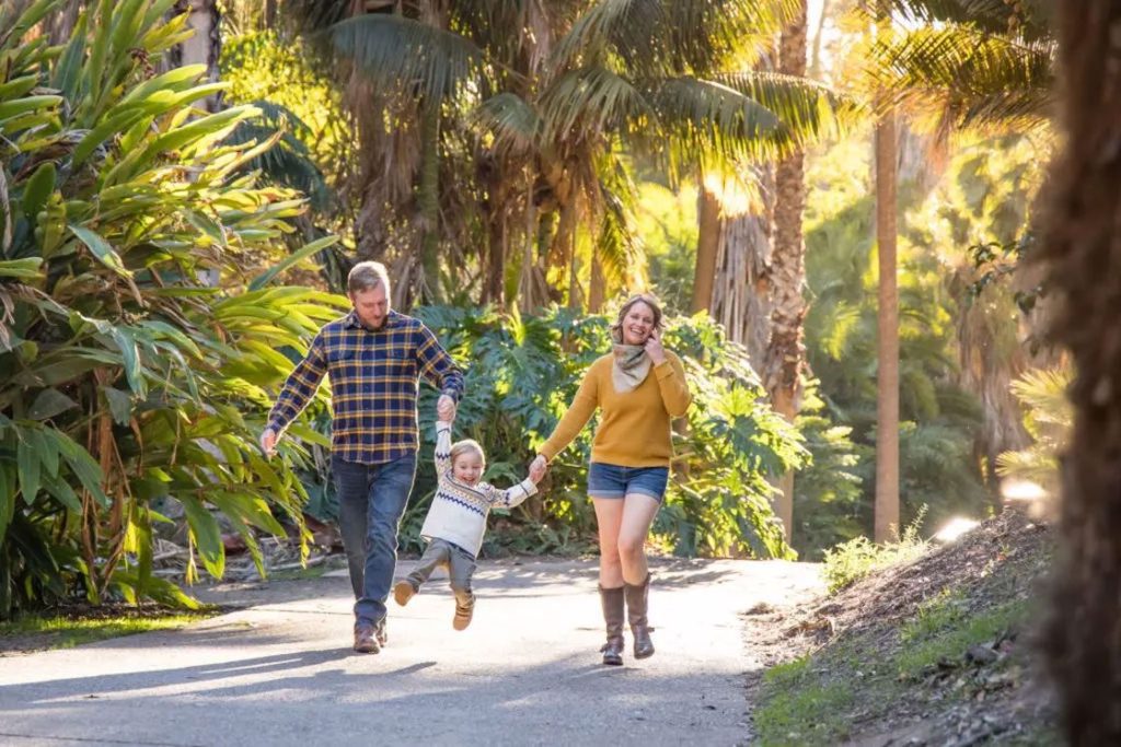 Couple swinging their child for a family shoot