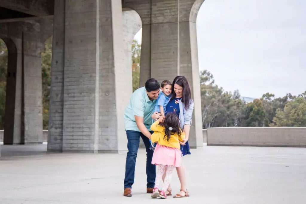 Parents preparing their kids in between their family shoot
