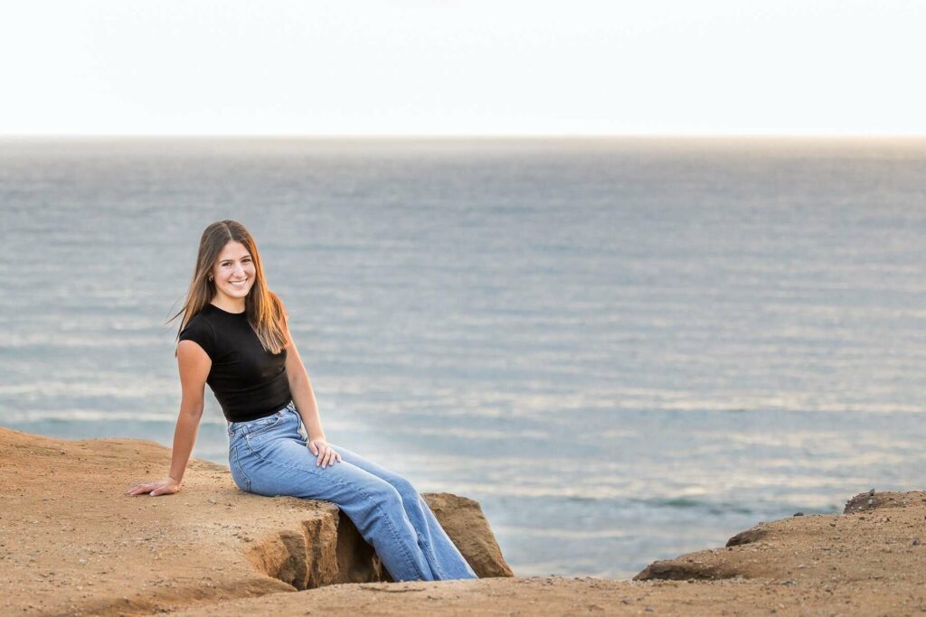 A senior student on a beach posing for her senior photograph