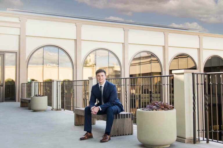 A grad student wearing formal suit for his senior portrait