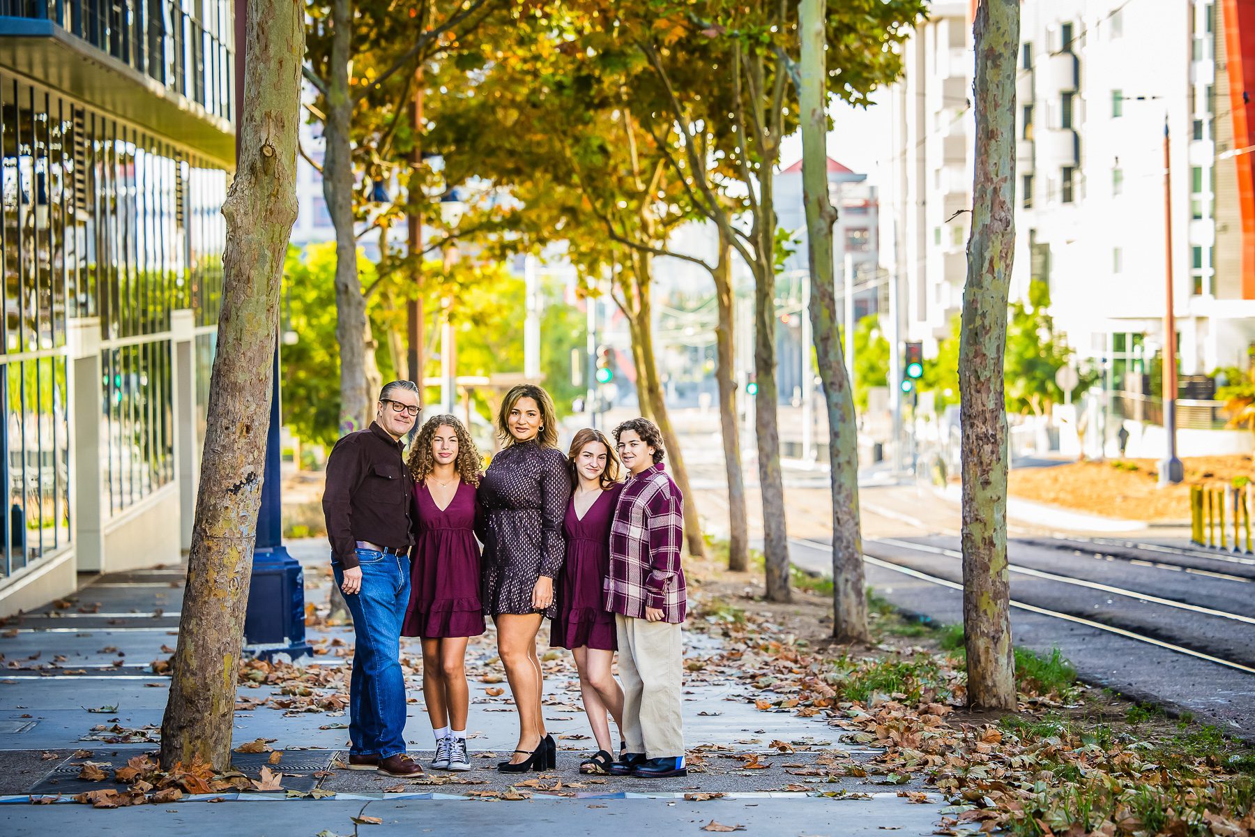 A family stands together for a portrait in front of a building