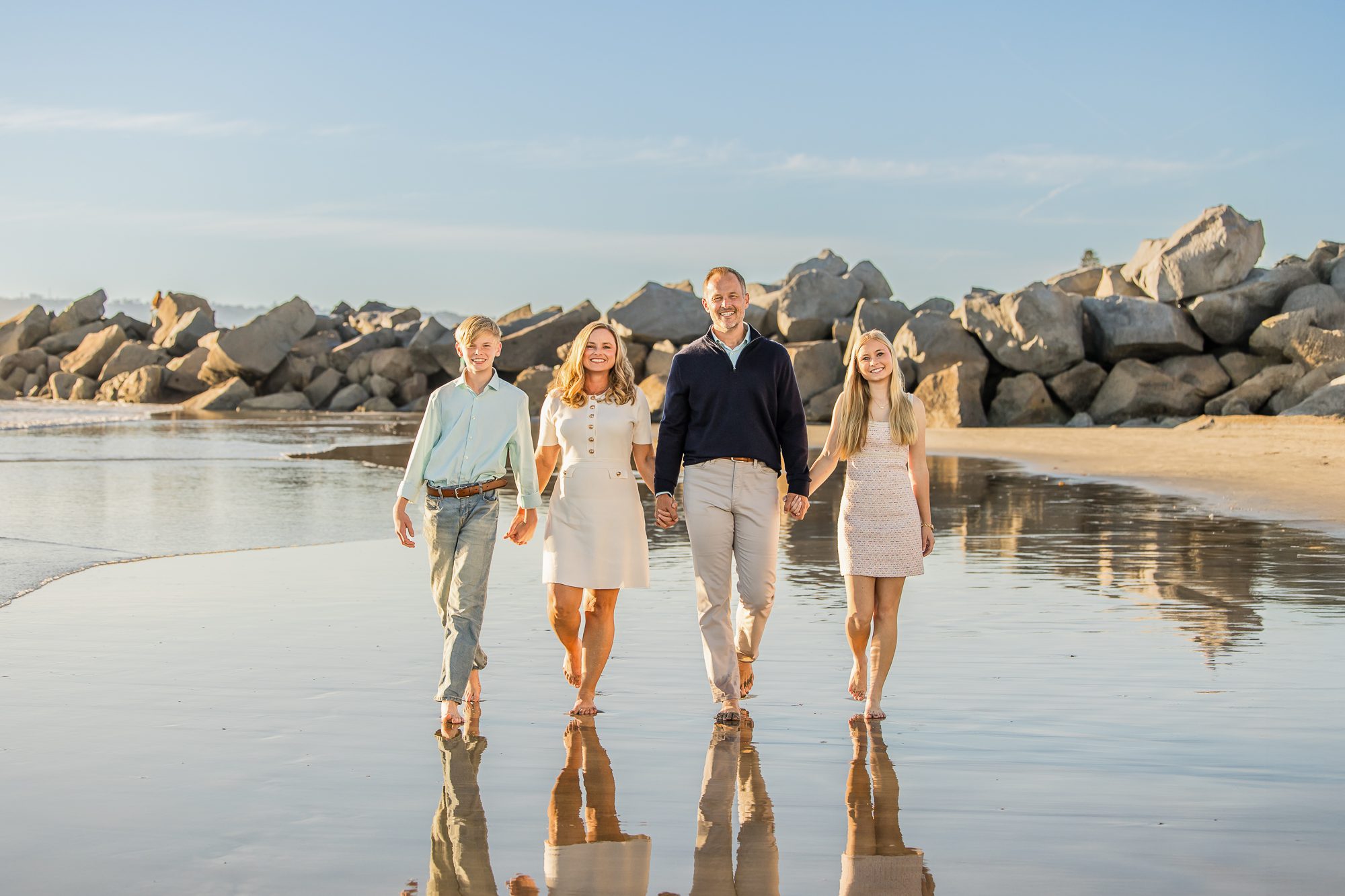 San Diego family laughing together on the beach during golden hour